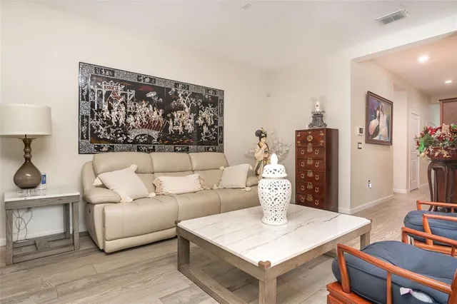 a living room with furniture a table and a painting