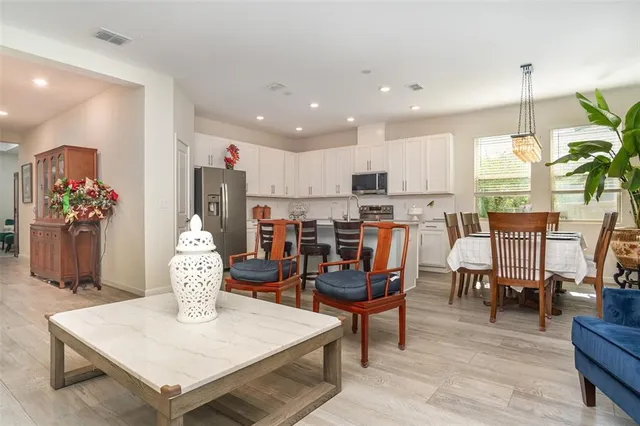 a living room with dining room and kitchen view