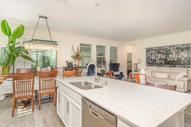 a kitchen with a sink a counter and chairs