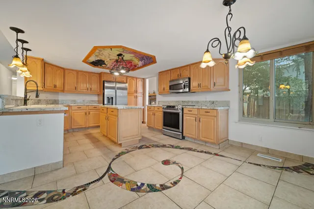 a kitchen with a stove a sink and a table