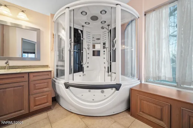 a bathroom with a bathtub sink and mirror
