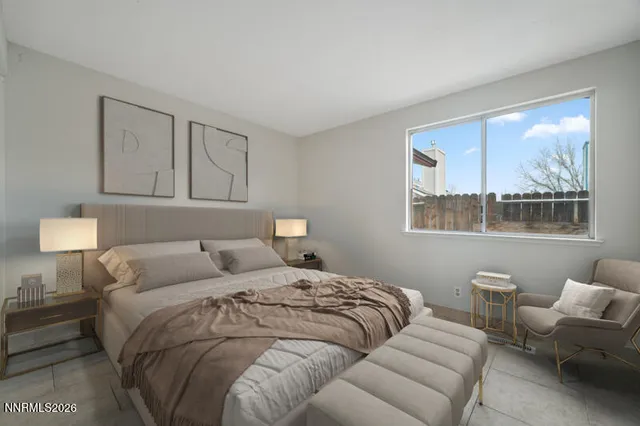 a bedroom with a bed and a large window