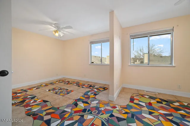 a bedroom with two beds and a lamp on dresser