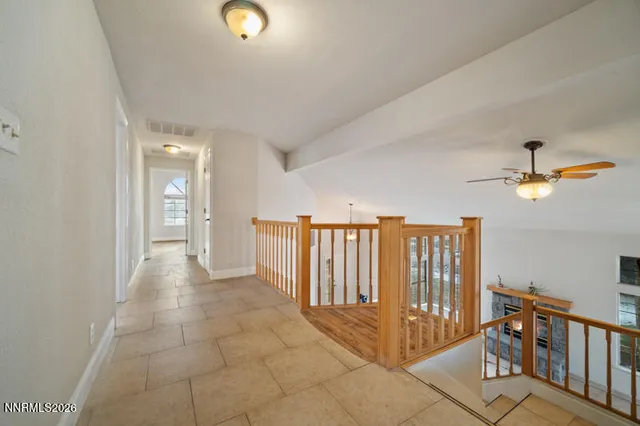a view of entryway with stairs and a chandelier fan