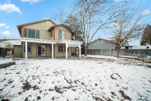 a front view of a house with a yard and trees