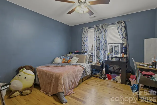 a bedroom with bed and a chandelier