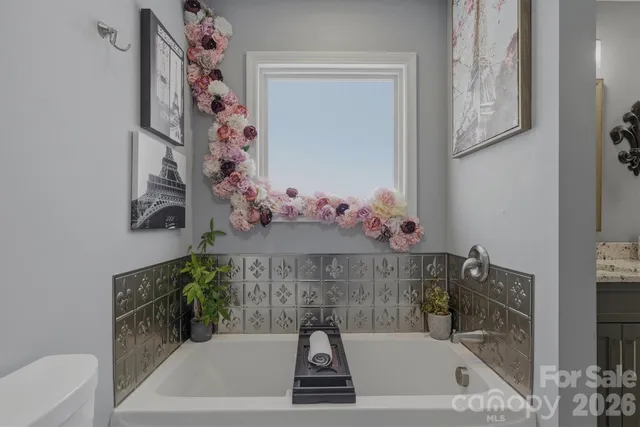 a bath tub sitting next to a bathroom sink
