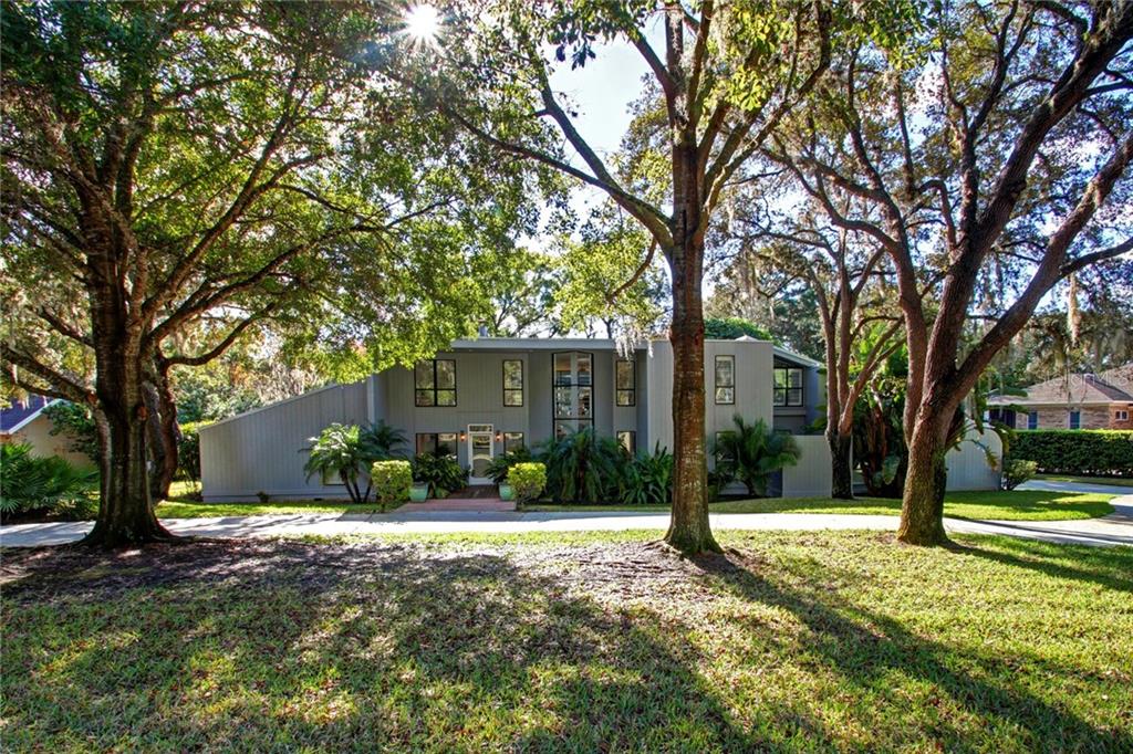 1043 Riverside Ridge Road Tarpon Springs, FL 34688 - Photo 1 of 1 a tree in front of a white house