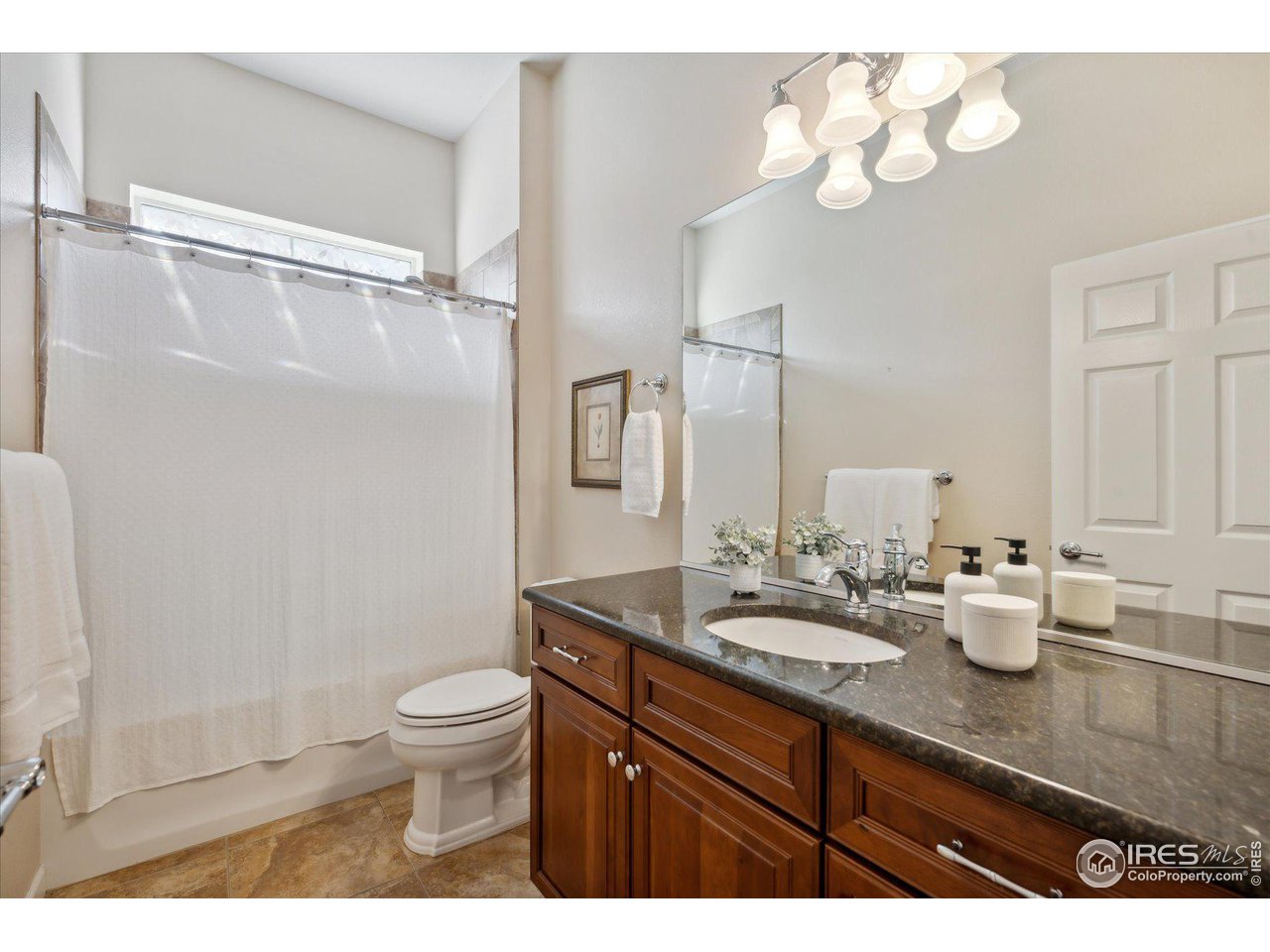 4514 Silver Mountain Loop Broomfield, CO 80023 - Photo 18 of 39 a bathroom with a granite countertop sink a toilet and a mirror
