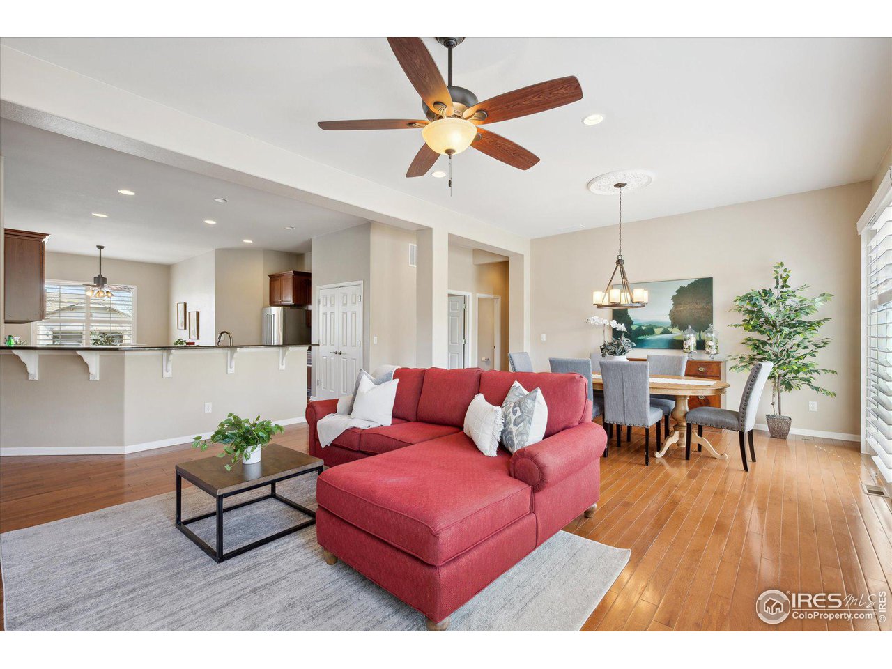 4514 Silver Mountain Loop Broomfield, CO 80023 - Photo 2 of 39 a living room with furniture kitchen view and a chandelier