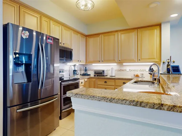 a dining room filled chandelier and kitchen view