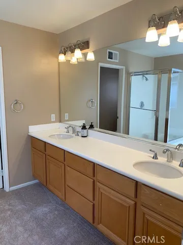 a bathroom with a double vanity sink and a mirror