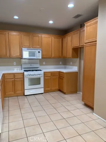 a kitchen with stainless steel appliances granite countertop a refrigerator sink and cabinets