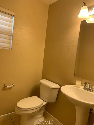 a white toilet sitting next to a bathroom sink