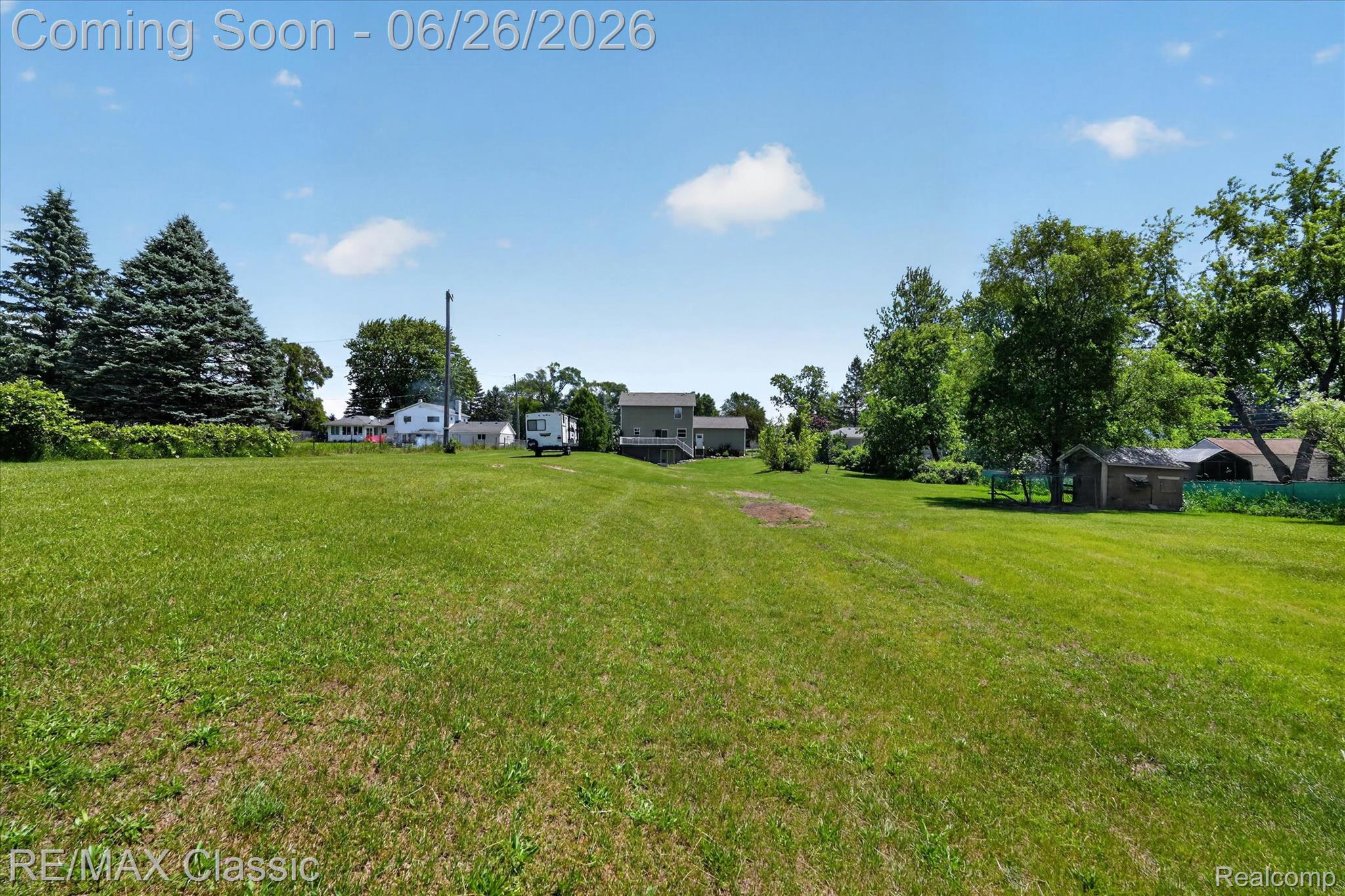 3205 North Milford Road Highland, MI 48357 - Photo 45 of 53 Expansive green lawn with mature evergreen trees and various deciduous trees providing natural screening