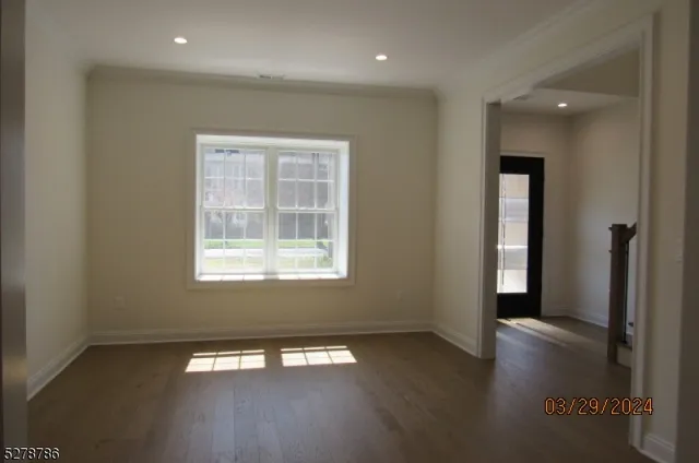 an empty room with wooden floor and a window