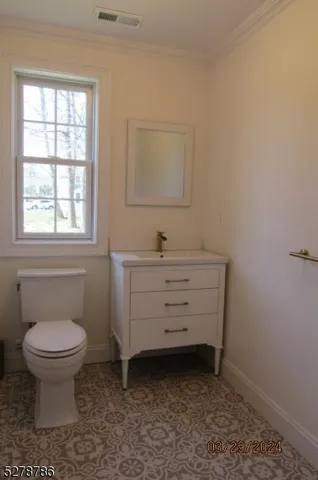a bathroom with a sink toilet and window