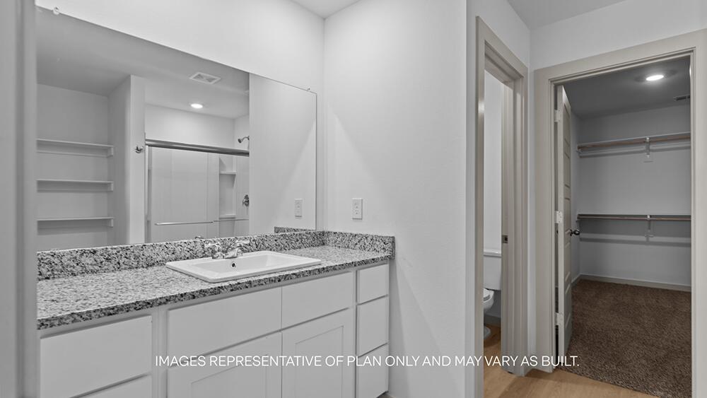 7448 9th Street Lubbock, TX 79416 - Photo 11 of 21 a bathroom with a granite countertop sink and a mirror