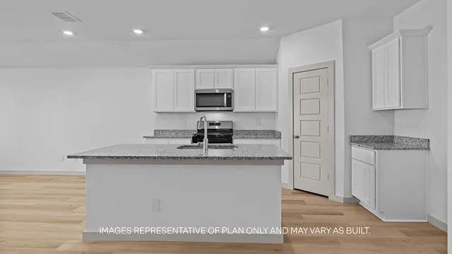 a kitchen with granite countertop a sink and a stove top oven
