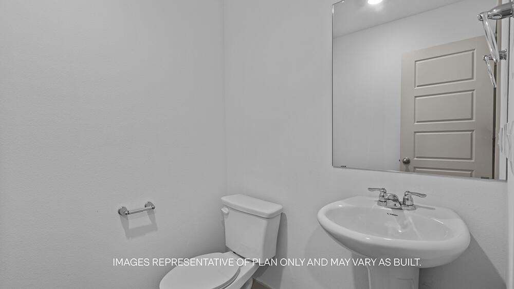 7448 9th Street Lubbock, TX 79416 - Photo 7 of 21 a bathroom with a sink and a toilet