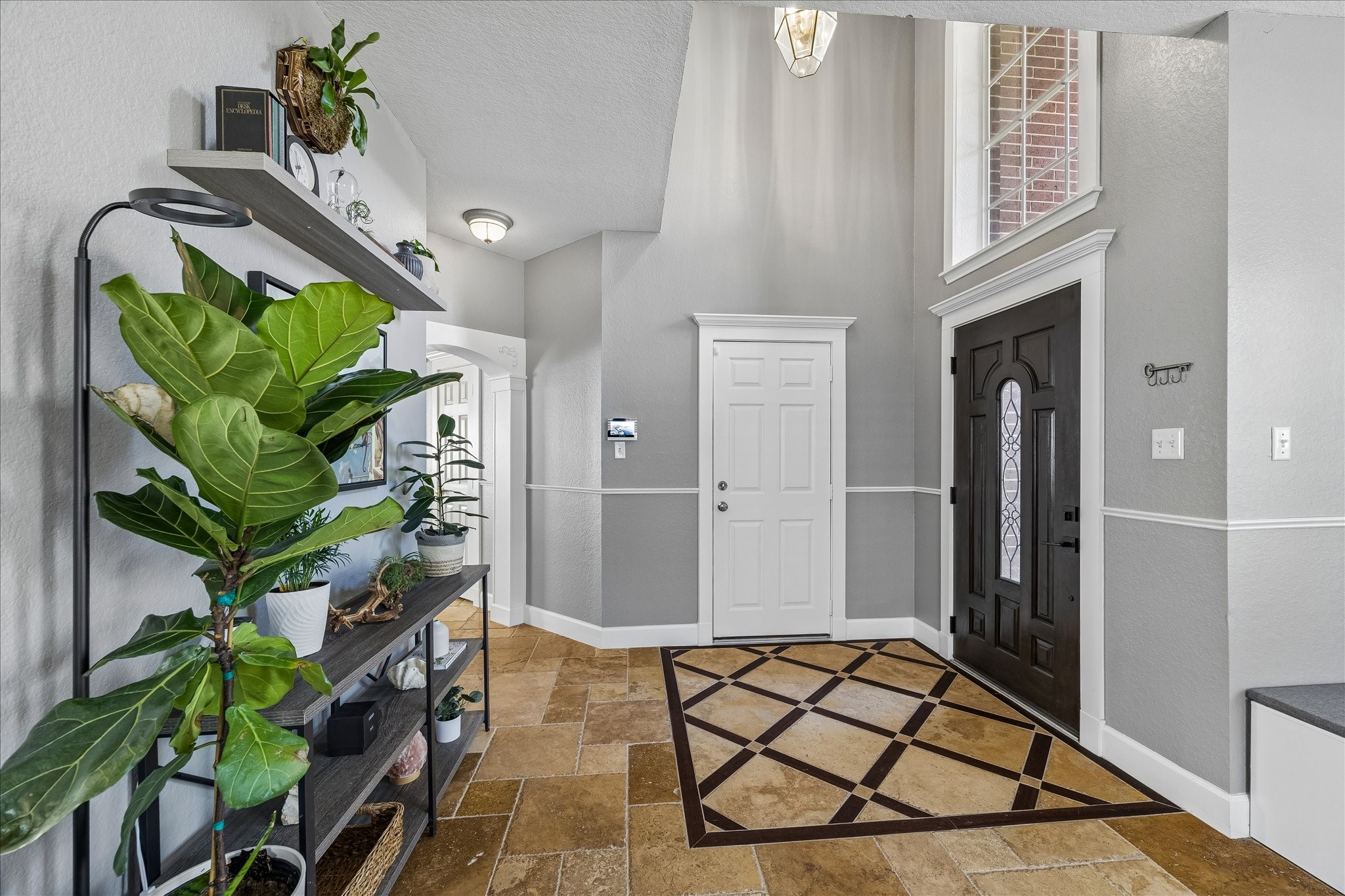 23234 Grand Rapids Lane Spring, TX 77373 - Photo 3 of 30 Grand two-story foyer welcomes you home with a striking geometric tile inlay, elegant lighting, and a stately front door.
