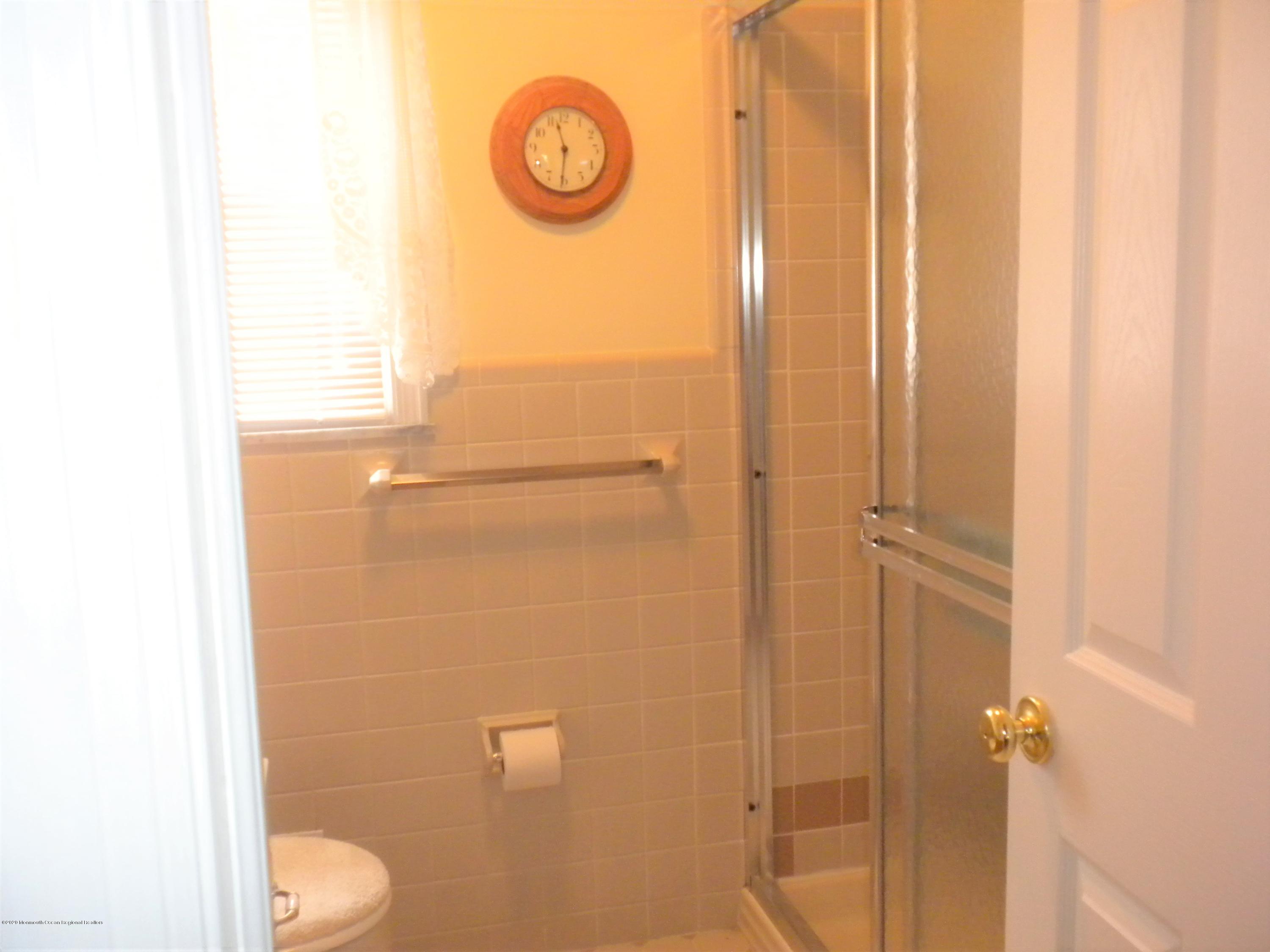 28 Ridge Road West Long Branch, NJ 07764 - Photo 14 of 19 a bathroom with a granite countertop shower and a toilet