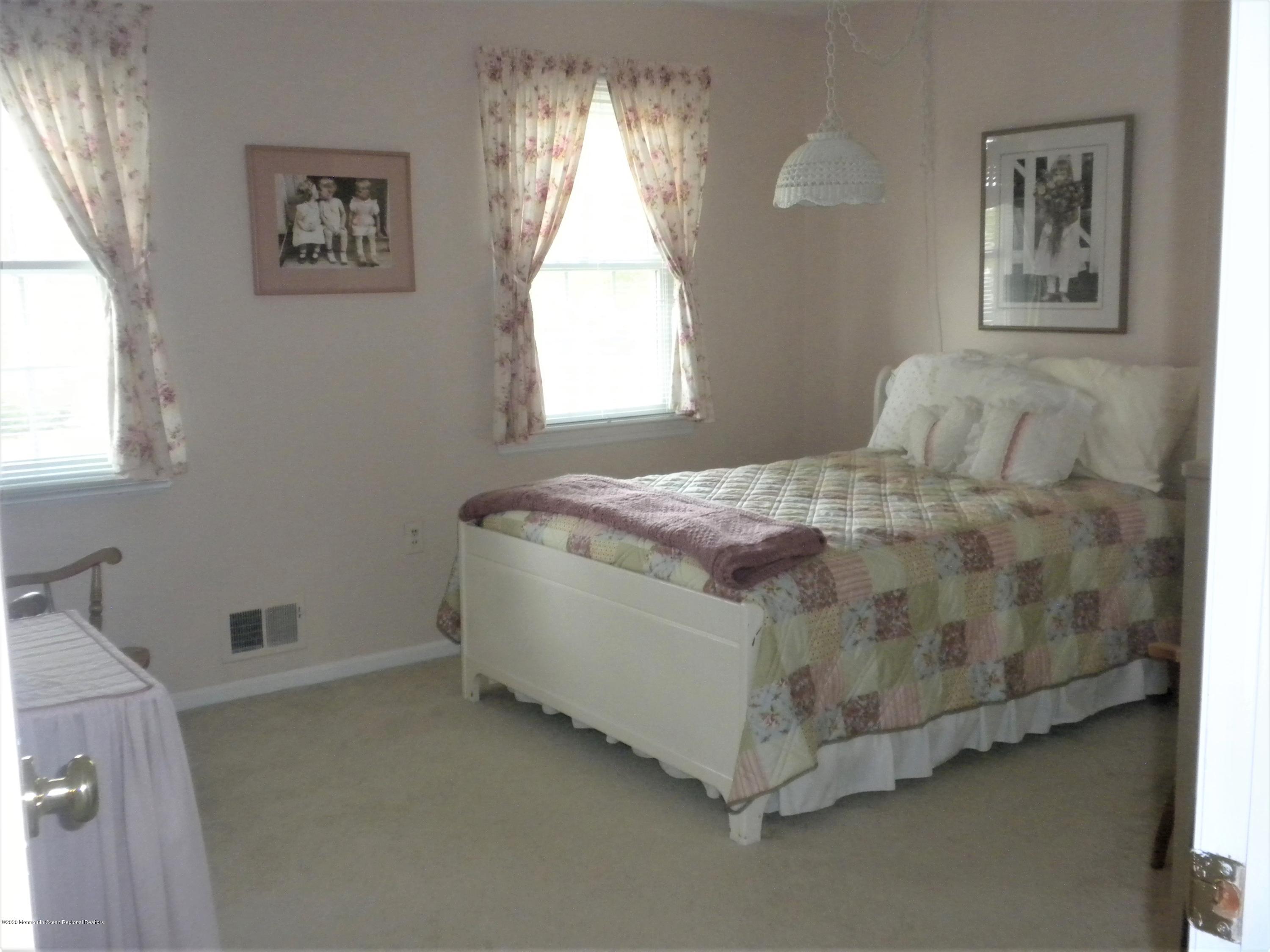 28 Ridge Road West Long Branch, NJ 07764 - Photo 16 of 19 a bed sitting in a bedroom next to a window