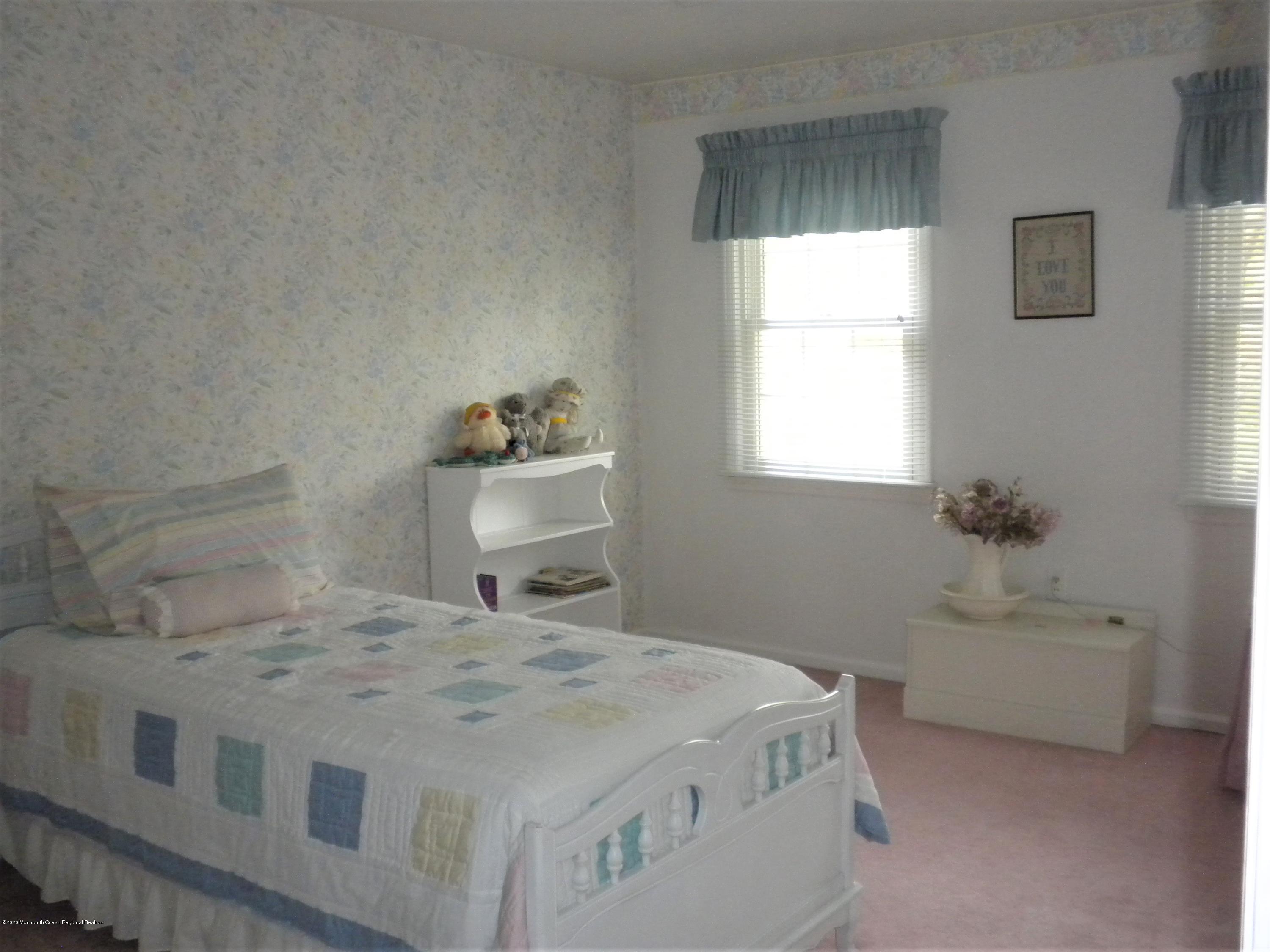 28 Ridge Road West Long Branch, NJ 07764 - Photo 17 of 19 a bedroom with a bed and a table in it