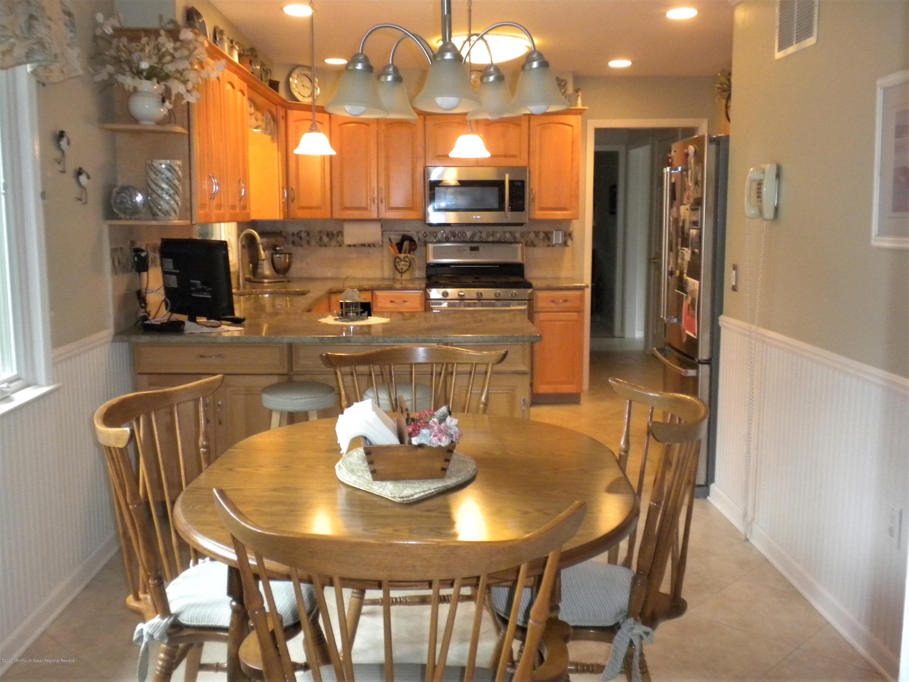 28 Ridge Road West Long Branch, NJ 07764 - Photo 4 of 19 a kitchen with a dining table and chairs