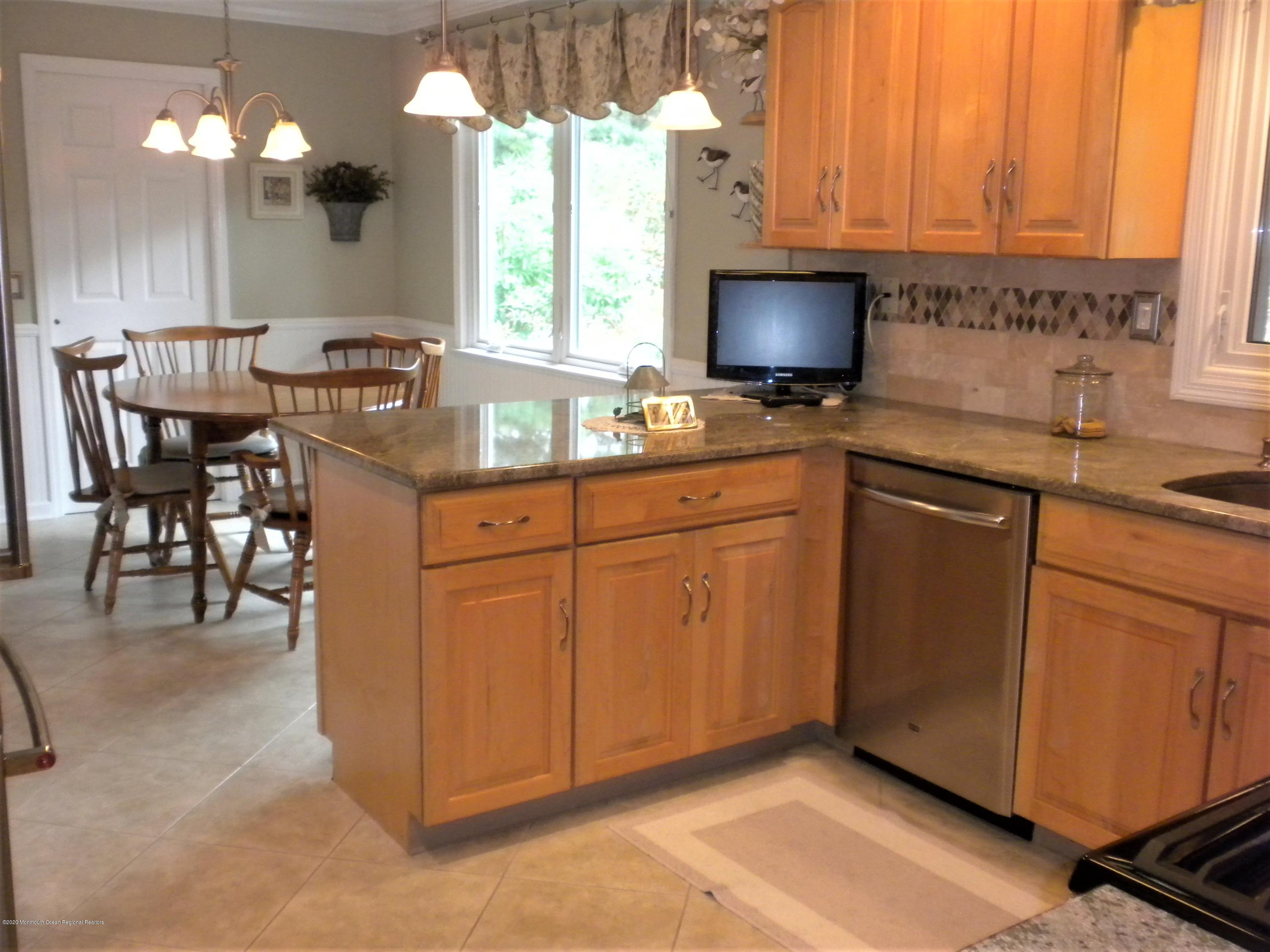 28 Ridge Road West Long Branch, NJ 07764 - Photo 5 of 19 a kitchen with stainless steel appliances granite countertop a sink a stove cabinets and a dining table