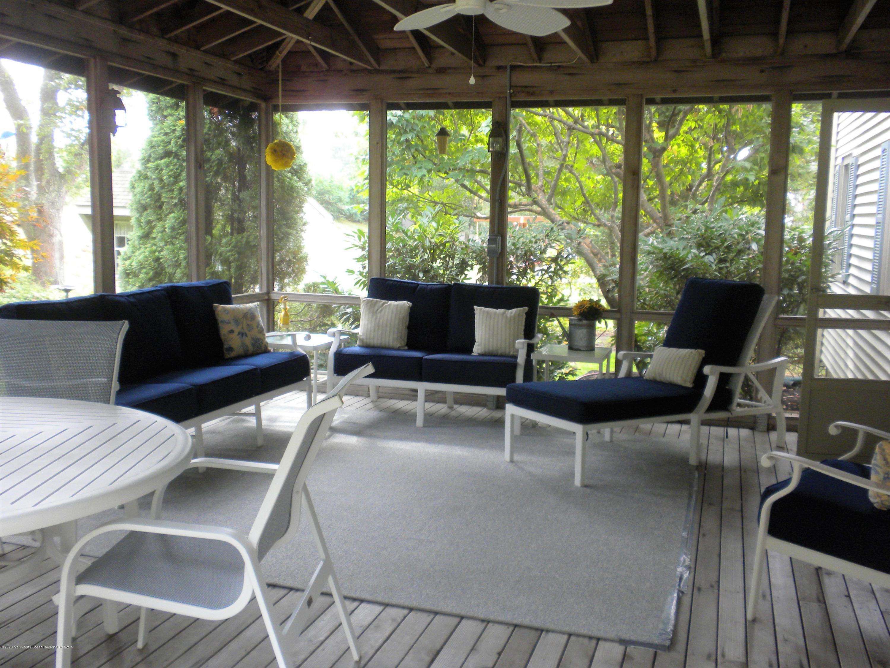 28 Ridge Road West Long Branch, NJ 07764 - Photo 8 of 19 a living room with furniture and a floor to ceiling window