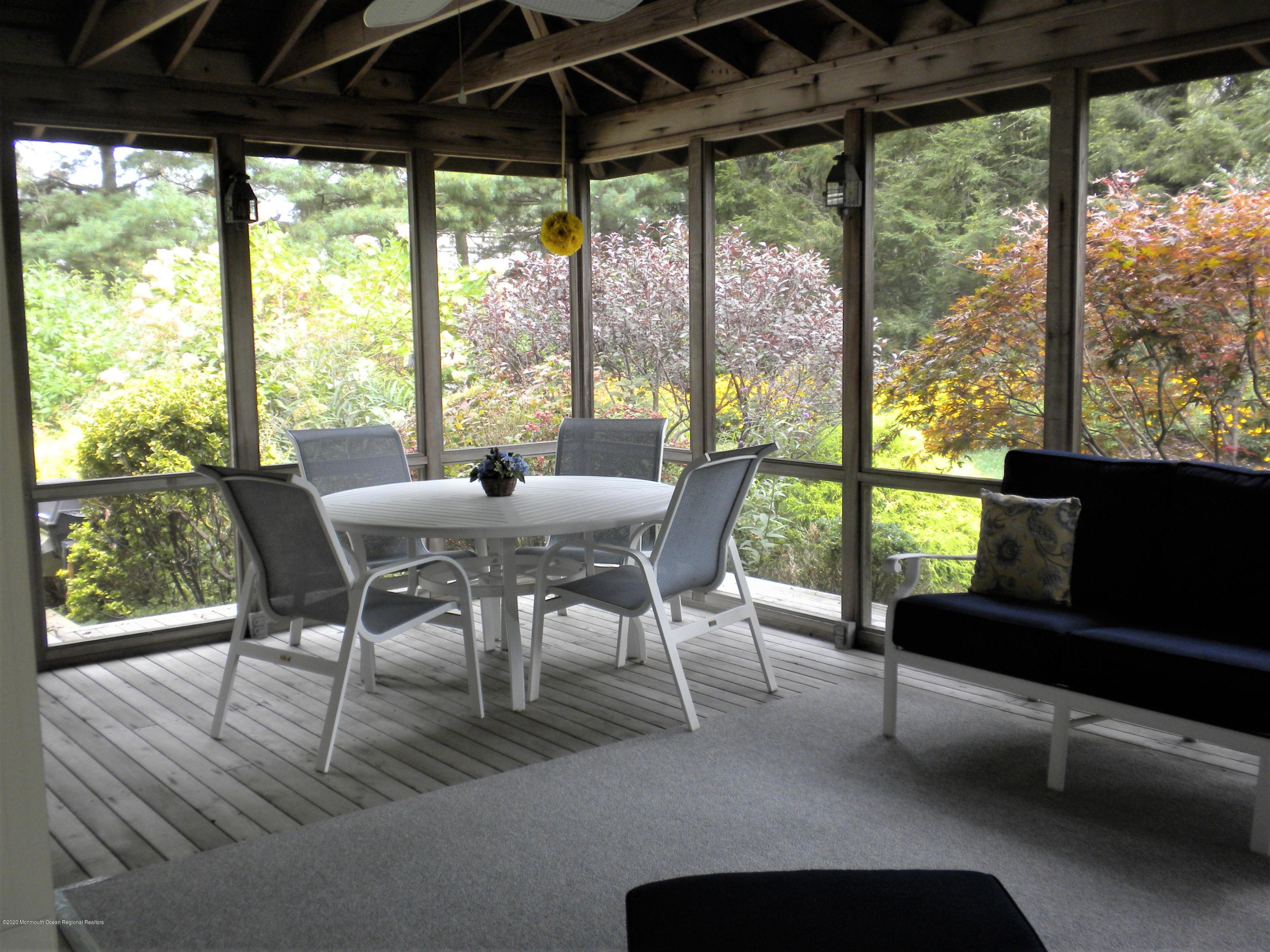 28 Ridge Road West Long Branch, NJ 07764 - Photo 9 of 19 a dining room with furniture and a floor to ceiling window