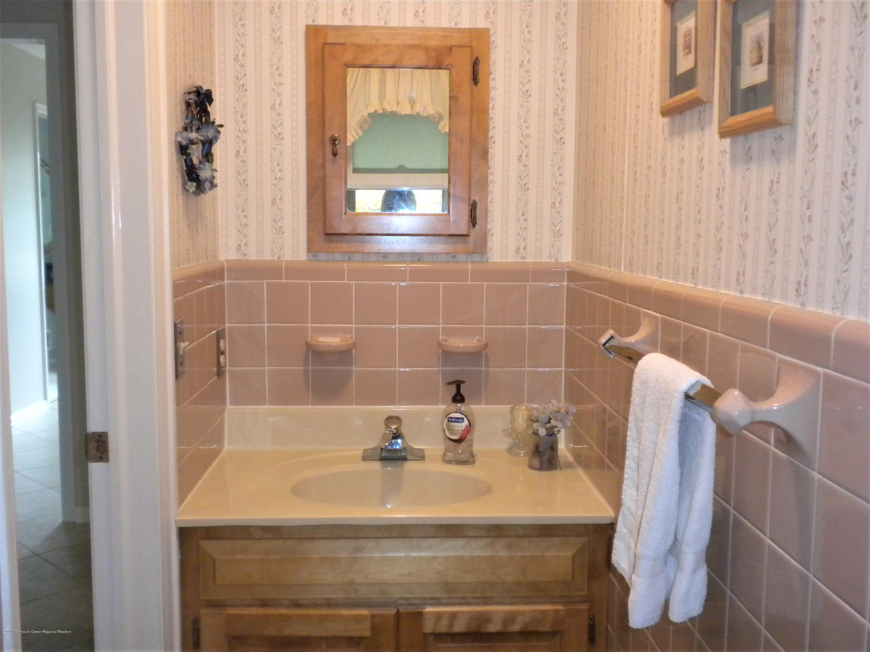 28 Ridge Road West Long Branch, NJ 07764 - Photo 10 of 19 a bathroom with a sink and a mirror