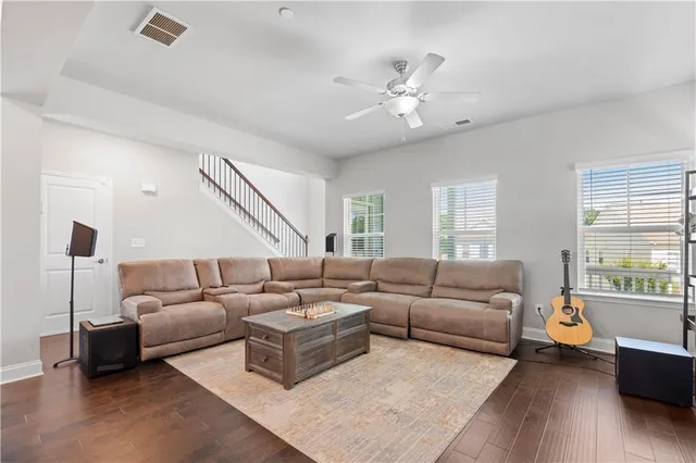 a living room with furniture and wooden floor