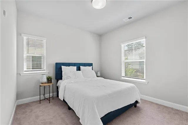 a bedroom with a bed table and a window