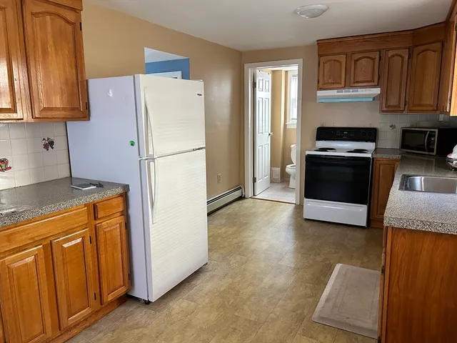 a white refrigerator freezer sitting in a kitchen