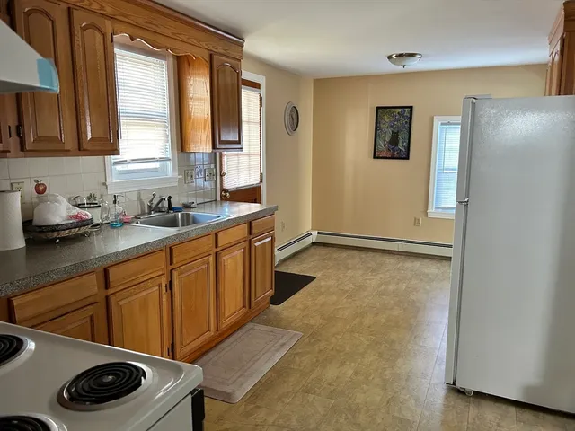 a kitchen with a refrigerator and a sink