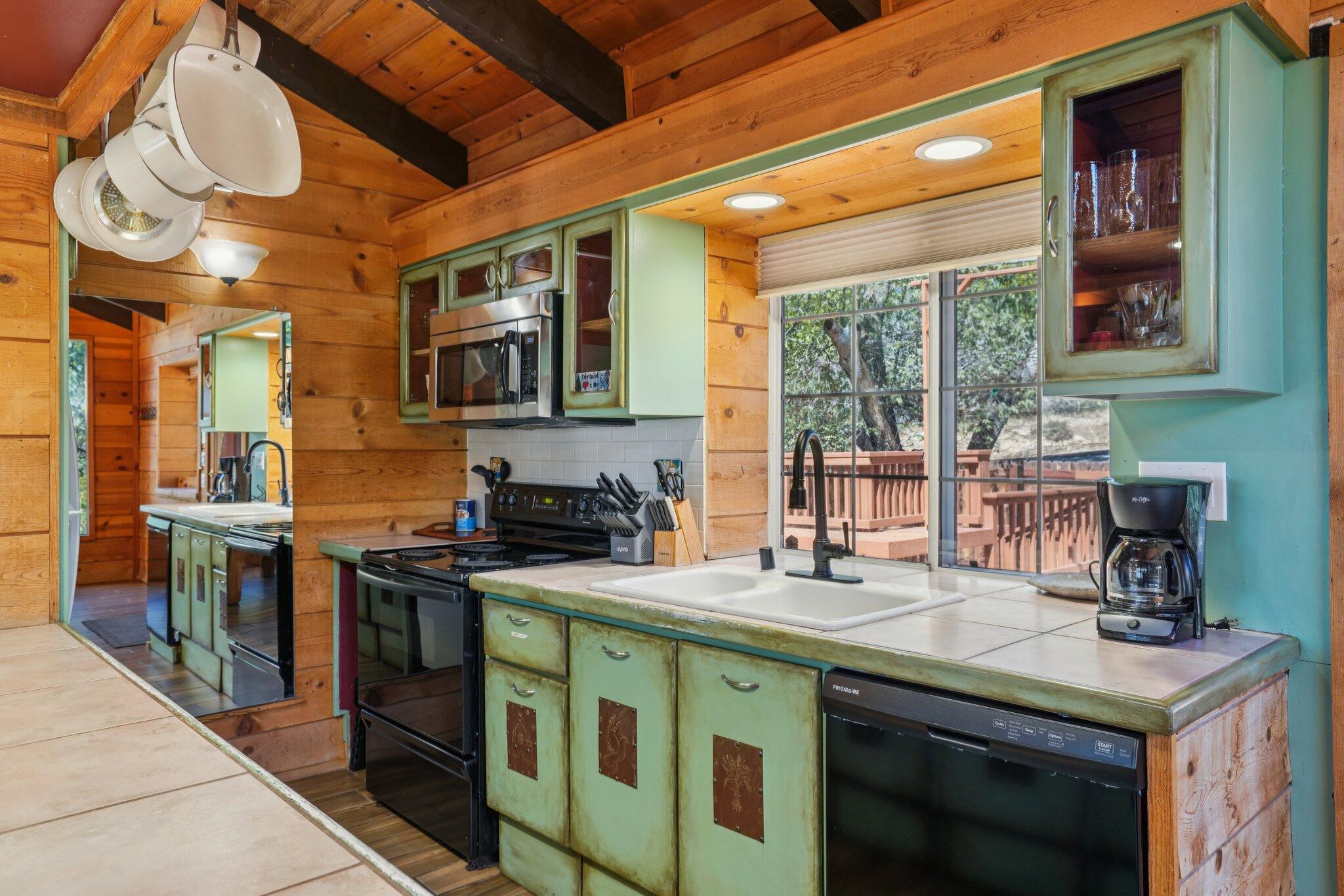 24800 Marion Ridge Drive Idyllwild, CA 92549 - Photo 13 of 39 a kitchen with stainless steel appliances granite countertop a stove a sink and a microwave