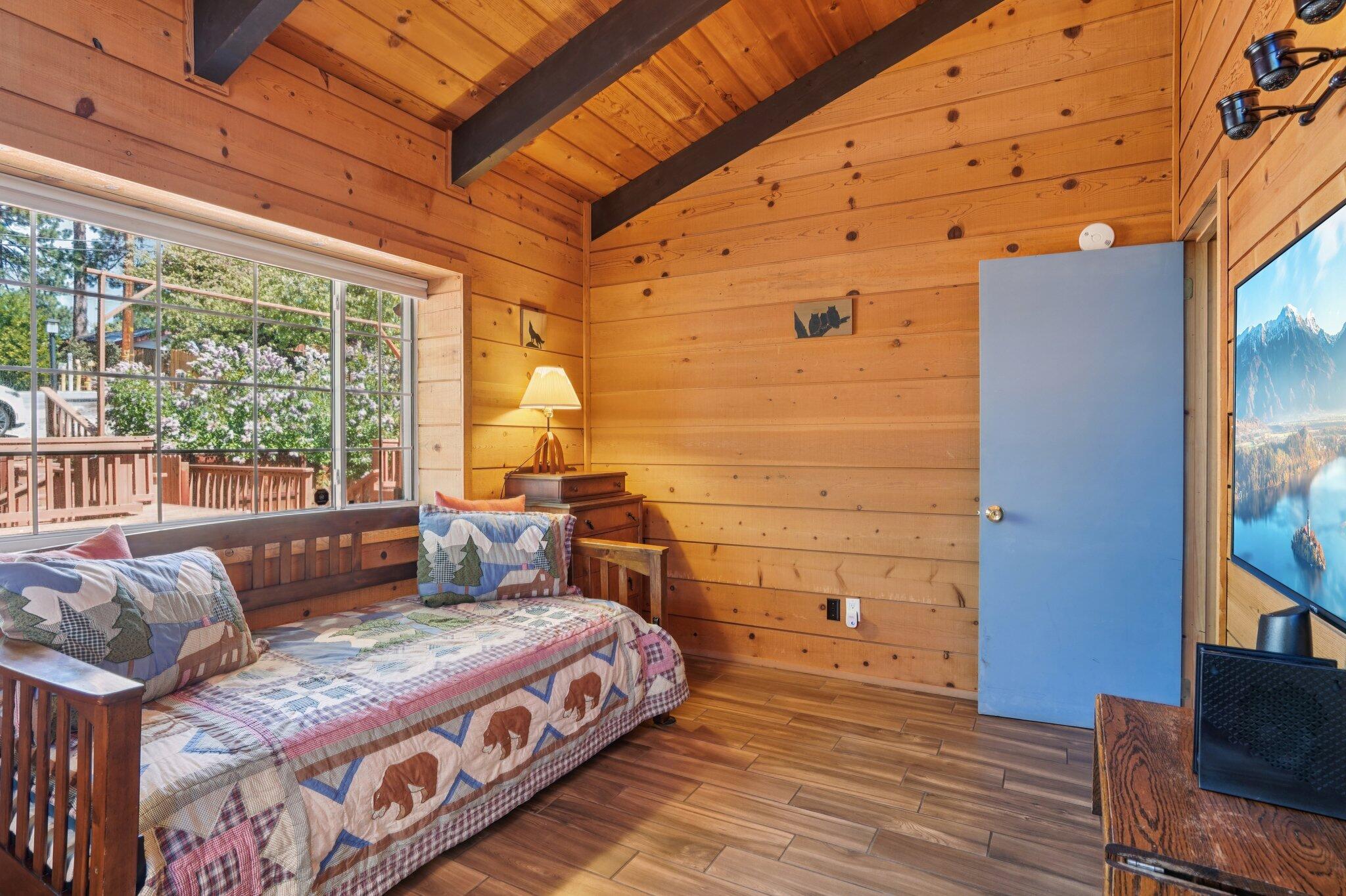24800 Marion Ridge Drive Idyllwild, CA 92549 - Photo 16 of 39 a spacious bedroom with a bed and wooden floor