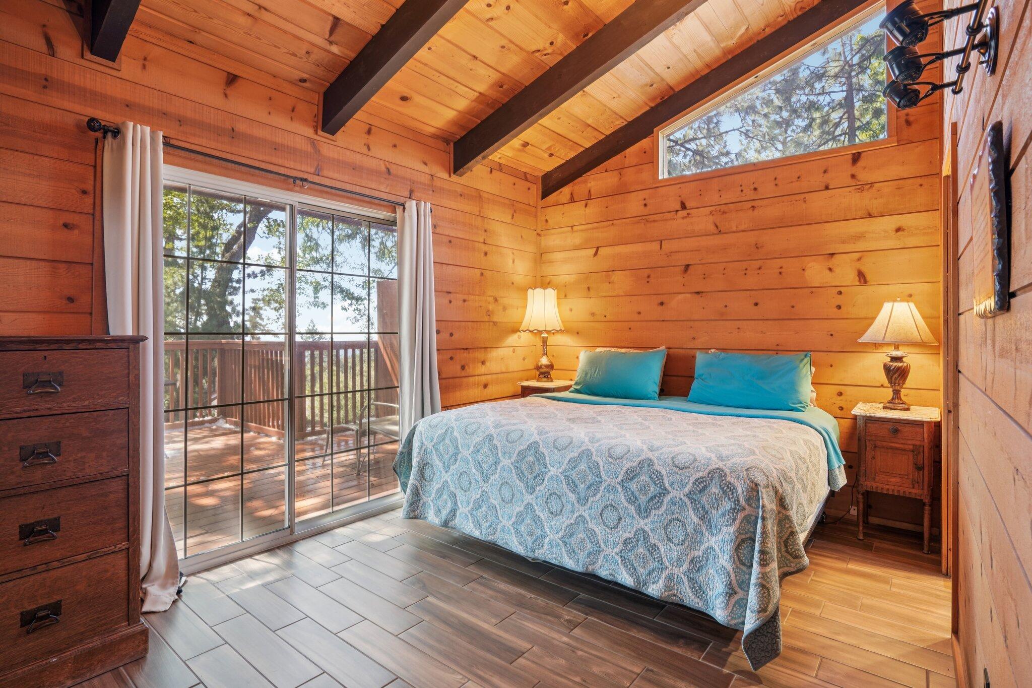 24800 Marion Ridge Drive Idyllwild, CA 92549 - Photo 19 of 39 a bedroom with a bed and wooden floor