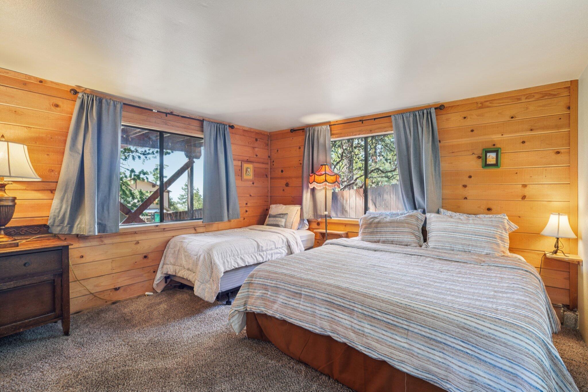 24800 Marion Ridge Drive Idyllwild, CA 92549 - Photo 24 of 39 a bedroom with two beds and large windows