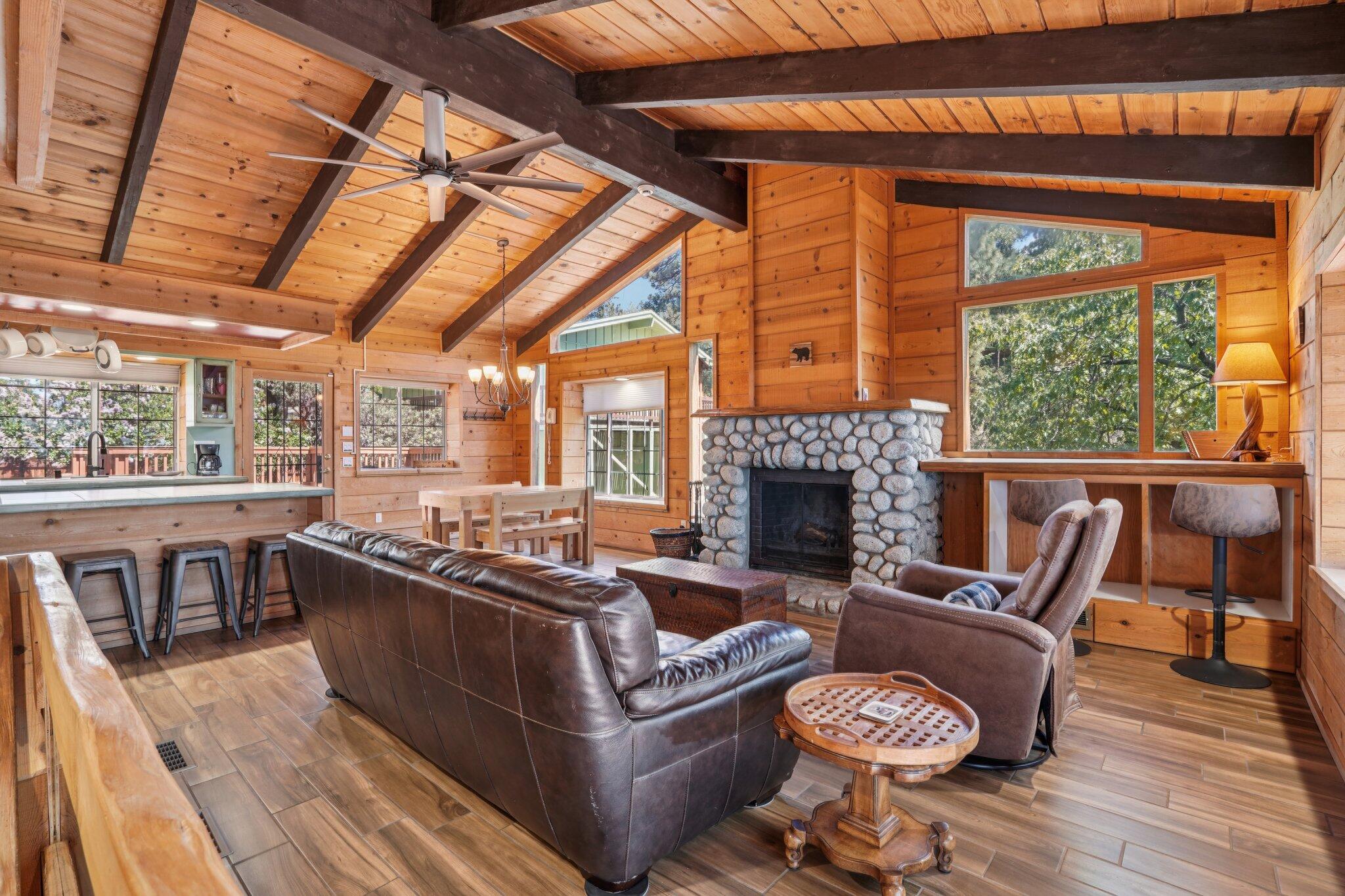 24800 Marion Ridge Drive Idyllwild, CA 92549 - Photo 3 of 39 a living room with furniture a fireplace and wooden floors