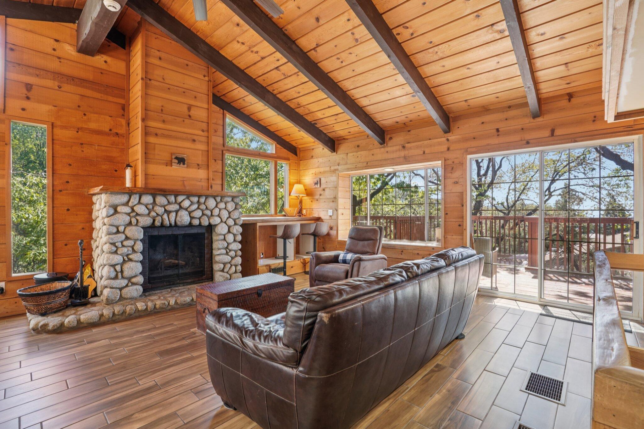 24800 Marion Ridge Drive Idyllwild, CA 92549 - Photo 4 of 39 a living room with furniture a fireplace and a table
