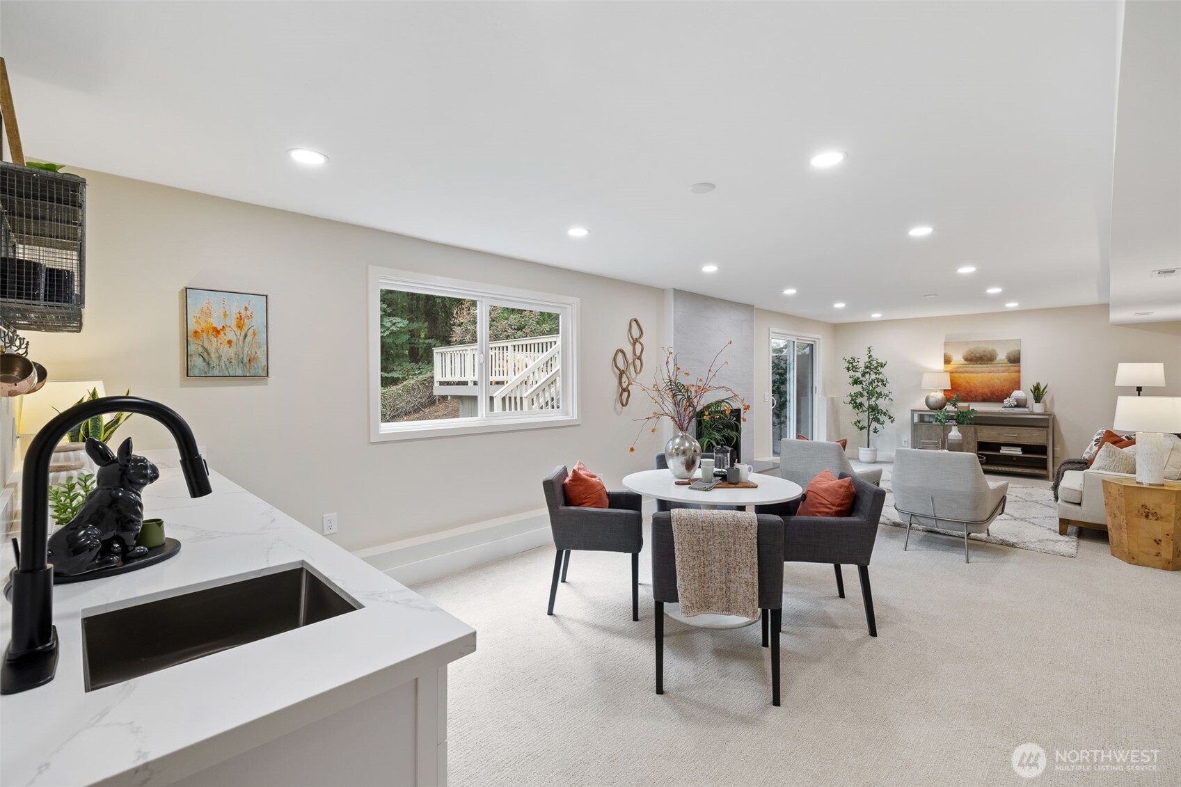 22017 1st Place West Bothell, WA 98021 - Photo 19 of 28 a living room with furniture a dining table and a stove with wooden floor
