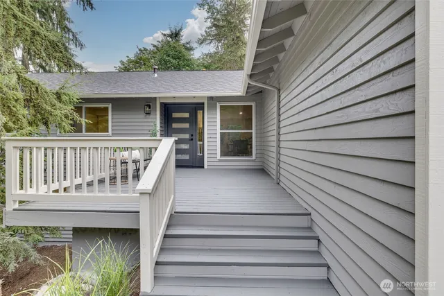 a view of a house with wooden deck