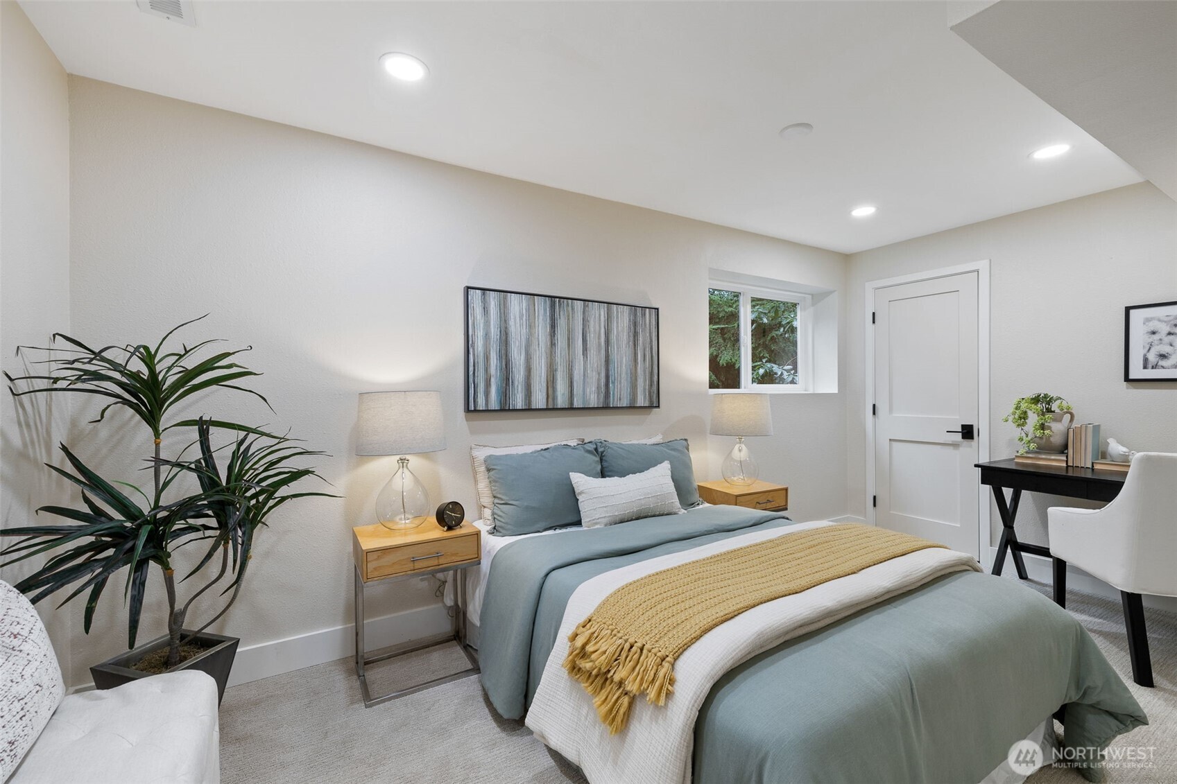 22017 1st Place West Bothell, WA 98021 - Photo 21 of 28 a bedroom with a large bed and a potted plant