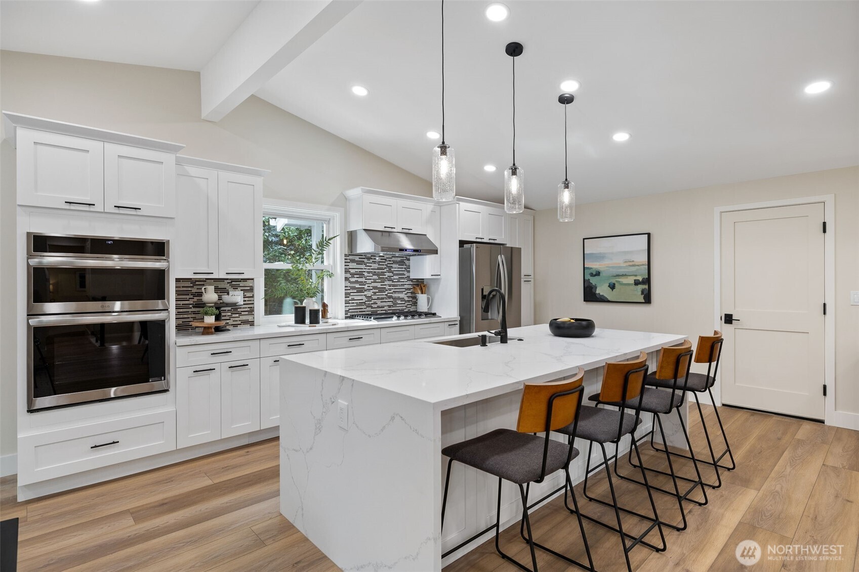 22017 1st Place West Bothell, WA 98021 - Photo 25 of 28 a kitchen with stainless steel appliances kitchen island granite countertop a stove a sink a microwave a dining table and chairs