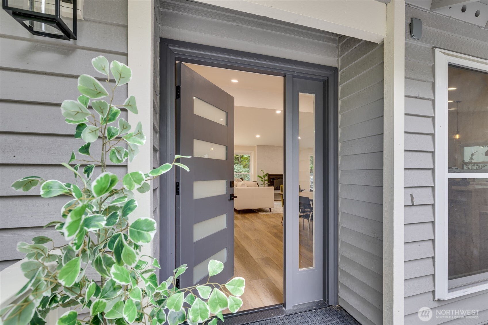 22017 1st Place West Bothell, WA 98021 - Photo 3 of 28 a potted plant in front of a glass door