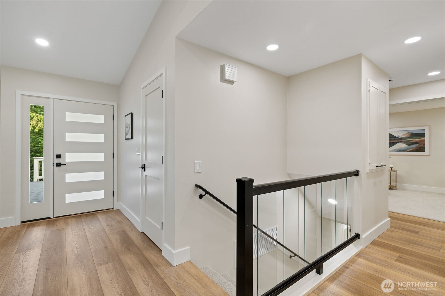22017 1st Place West Bothell, WA 98021 - Photo 8 of 28 a view of a hallway with wooden floor and staircase