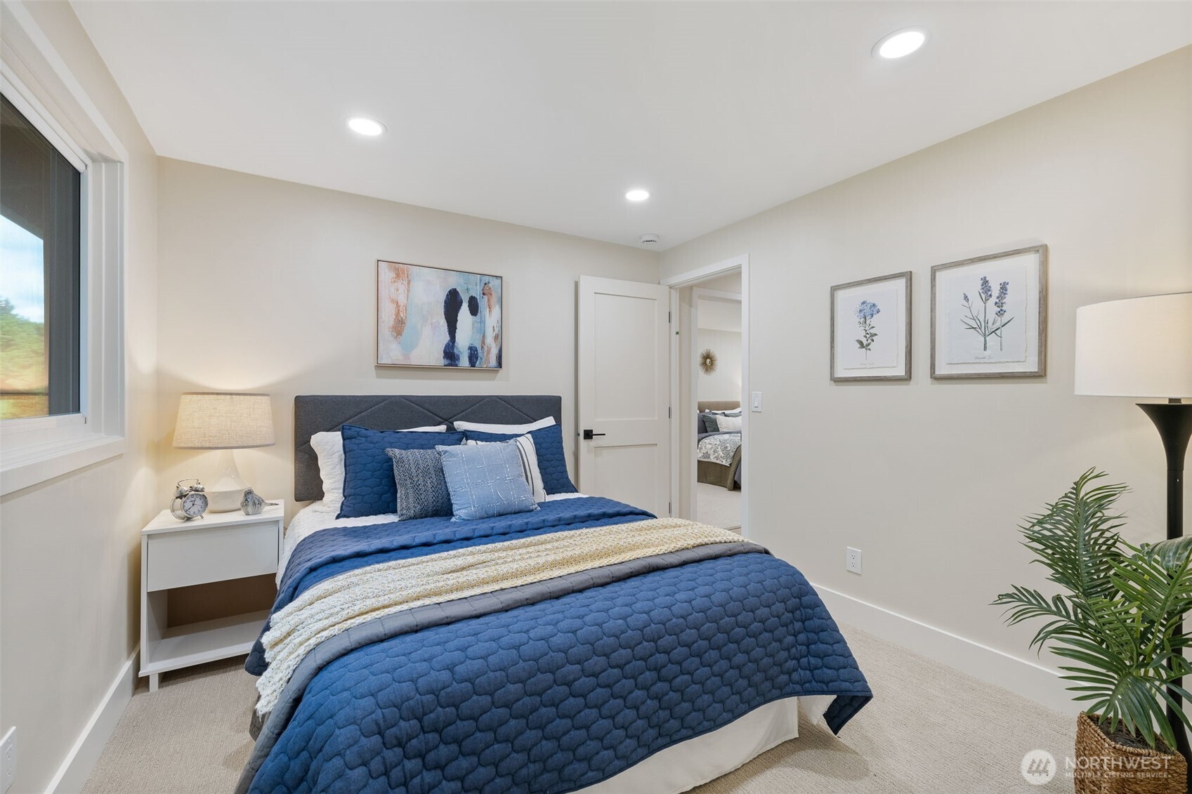 22017 1st Place West Bothell, WA 98021 - Photo 10 of 28 a bedroom with bed and paintings on the wall